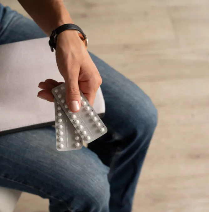 Woman holding contraceptive medication
